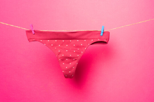 Female underwear. Woman lingerie on clothesline. Colorful erotic panties. Women's underpants on rope.