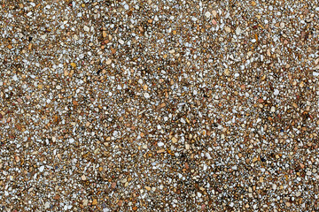 Abstract background paving consisting of small pebbles embedded in cement