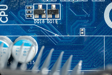 several small microcircuits and transistors on the motherboard next to the processor in a personal computer close-up