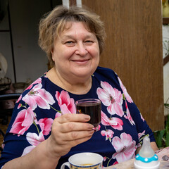 The cheerful mature woman smiled at the photographer.