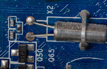 microcircuits and transistor on a motherboard inside a personal computer close-up