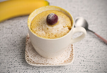 muffin in a mug with banana flavor. Muffin banana cooked in the microwave. Homemade baking. Simple cooking concept. High quality photo