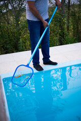 person cleaning the pool