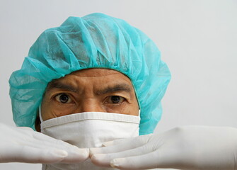 doctor with face mask and white gloves in hospital with white background stock photo