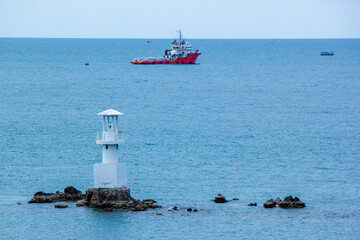 boats in the harbor ,lighthouse on the coast , Koh Samae San, Sattahip, Chonburi, Thailand