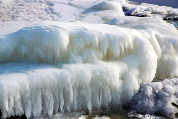 Ice covered rocky coast of the Baltic Sea on wintertime in Latvia. White snow, ice covers the land...