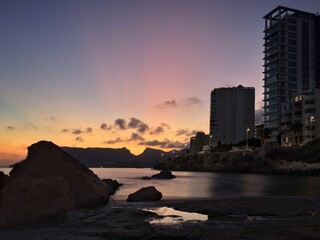 Apartment tower on quiet and beach at sunset.