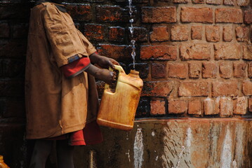 Enfant &agrave; la recherche d'eau potable au Burundi en Afrique, bidon, soif