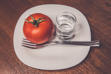 vodka and tomato on a white plate