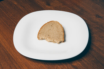 
bread on a white plate on a wooden background