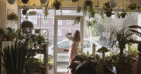 Small business entrepreneur Store Owner Turning Open Sign In Shop Doorway window