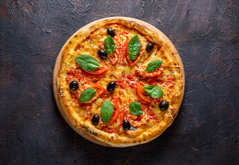 Freshly baked pizza with cheese and tomatoes. Top view.