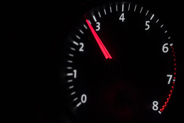 Car tachometer on a black background. traffic, gas, race. Engine speed