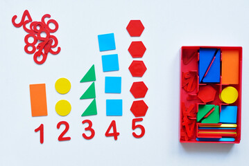 The child learns Number line and geometric shapes. The preschooler works with Montessori material. Educational logic toys for kid's. Children's hands close-up. Montessori Games for Child Development.