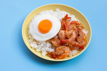 Spicy stir fried prawns with fried egg on rice