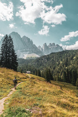 Fototapeta na wymiar Mountain hikers in the Dolomites, Italy. Odle mountain peaks.