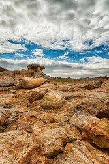 Landscape with rocks. Sunny day, blue sky with clouds