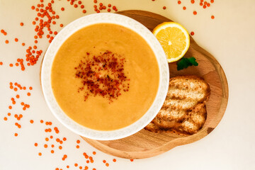 Lentil souo with bread and lemon.  top view.