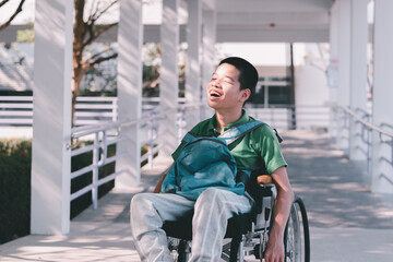 Fototapeta na wymiar Asian special child on wheelchair is smiling face as happiness on ramp for disabled people background in hospital, Lifestyle in the education age of disabled children, Happy disability kid concept.