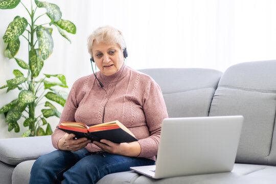 Elderly Woman With Bible And Laptop In Front Of Her Connected To Online Church Services Durring The Covid 19 Outbreak