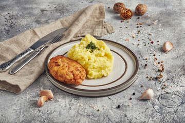 Mashed potatoes with cutlet, light background