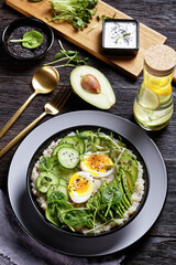 quinoa bowl with greens, avocado and boiled egg