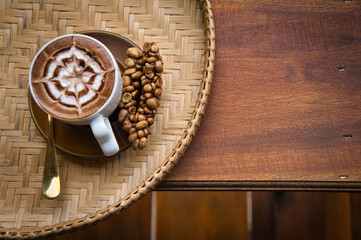 Fresh coffee in civet glass placed on a rattan tray
