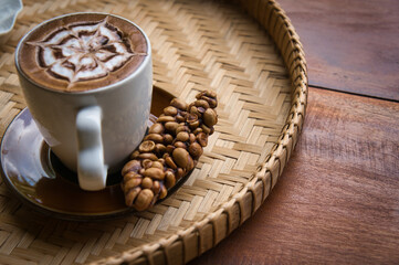 Fresh coffee in civet glass placed on a rattan tray