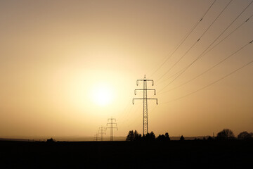 Power pole delivers energie to the sun, dust from sahara dessert in the atmosphere