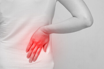 Person woman feels pain in the side of the body and back