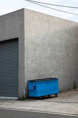 Fototapeta na wymiar Industrial waste container dumpster bin outside a factory floor.