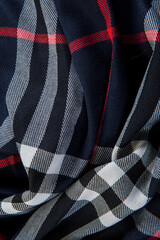top view flat lay closeup part of folded dark blue checked scarf