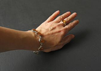 Citrine bracelet. Bracelet made of stones on hand from natural stone Citrine. Bracelet made of natural stones. Handmade jewelry. Handmade bracelets on light modern background
