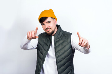 young handsome man - in stylish vest and white t-shirt thumbs up smiling
