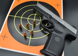 9mm Handgun Pistol with Target and Bullets at the Shooting Range