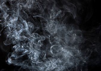 Abstract puffs of smoke on a black background.