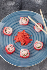 California sushi rolls and pickled ginger on blue plate
