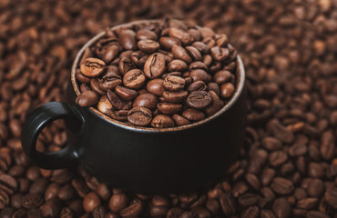 Top view on coffee cup full with coffee beans. Coffee background concept.