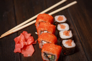 delicacy sushi and rolls on the table wooden sticks ginger wasabi top view