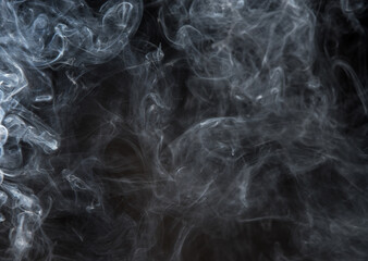 Abstract puffs of smoke on a black background.