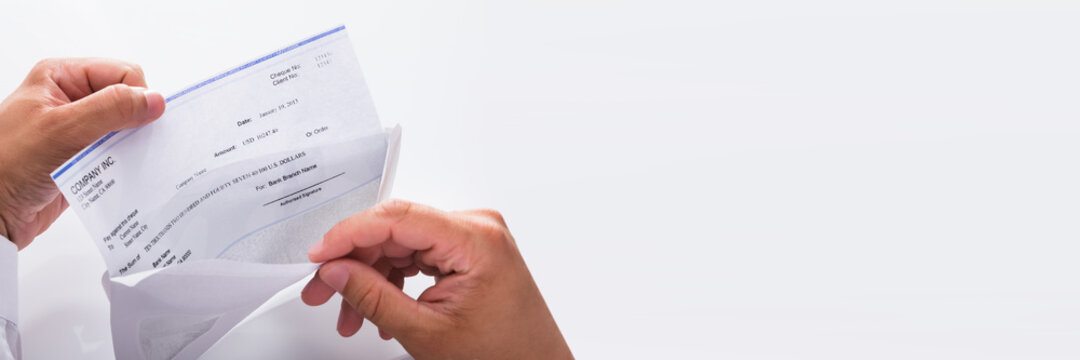 Businessman opening envelope with paycheck
