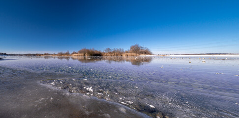 Hollener Bavarian lake during winter time with sun and blue sky background