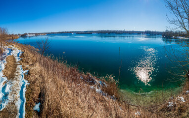 Hollener Bavarian lake during winter time with sun and blue sky background
