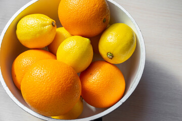 Mix of fruits from lemons and oranges in an old kitchen pan. Vitamins. The concept of healthy eating, cooking healthy food, eating foods with vitamin C.