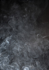 Abstract puffs of smoke on a black background.