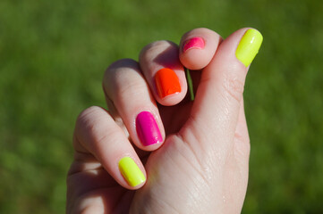 Female hand with colorful nails