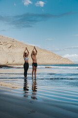 young man and woman exercise on the beach outdoors in a healthy way