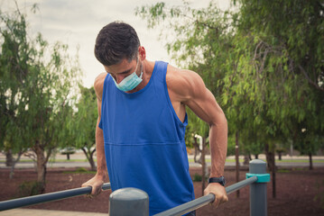young man exercises with face mask outdoors