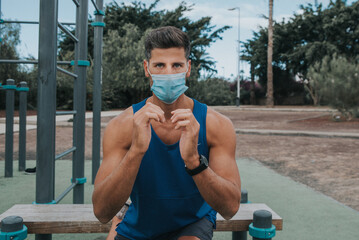 young man exercises with face mask outdoors