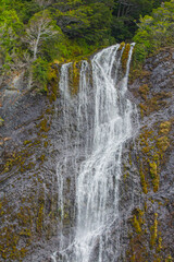Cascading down dramatic granite cliffs, this waterfall pours into the Baker Channel in the Parc Nacional Bernardo O'Higgins in Chile.
